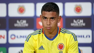 A 25-year-old Colombian midfielder, dressed in the vibrant yellow and blue home kit of Colombia with the Los Cafeteros...