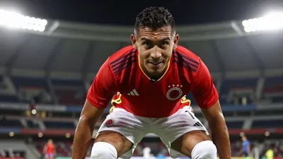 A photorealistic image of a Colombian national team player, wearing a red jersey with white shorts and socks, with a...