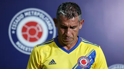 A 35-year-old Colombian midfielder, with a rugged, weathered complexion and graying temples, looks dejected as he stands...
