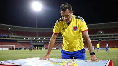 Ruggedly-built, Colombian national team coach in a yellow home jersey with a blue short and the club crest of Los...
